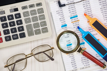 Business and accounting supplies arranged in a composition on an office desk. Top view.