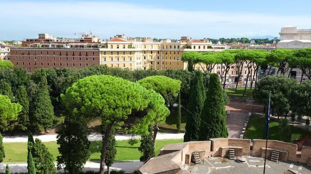 elevated castel sant angelo overlooking rome gardens umbrella pines elegant yellow buildings vittoriano rises beyond sant'angelo from view italy roman empire emperor 