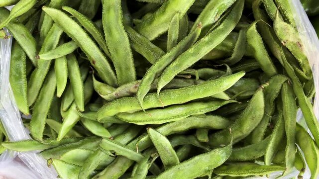 fresh green cluster beans piled in plastic bag at local vegetable market