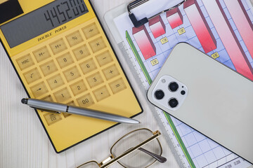 Business and accounting supplies arranged in a composition on an office desk. Top view.