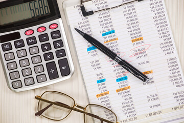 Business and accounting supplies arranged in a composition on an office desk. Top view.