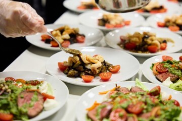 Professional cook preparing salad in restaurant kitchen