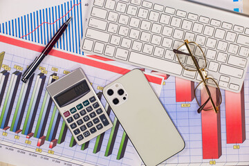 Business and accounting supplies arranged in a composition on an office desk. Top view.
