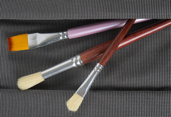 Art brushes peeking out of a pocket.