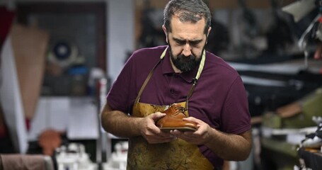 Skilled Shoemaker Inspects a Handcrafted Leather Shoe in his Traditional Workshop, Emphasizing Quality and Craftsmanship