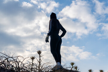 Woman hiking mountain enjoying outdoor winter adventure