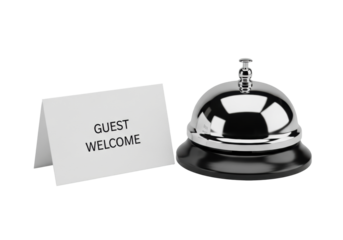 Reflective chrome service bell with round push-button and dark matte base, beside a crisp white guest welcome card on a seamless transparent background, concept for high-end product display