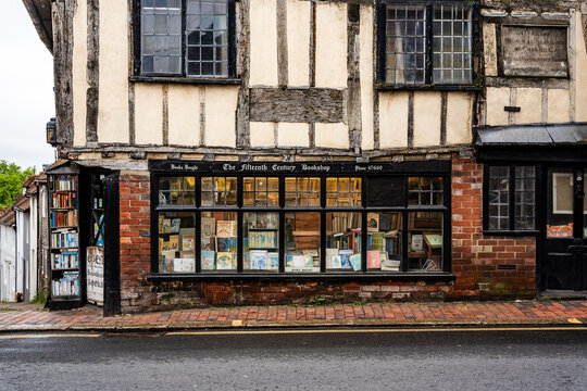 Exterior view of The Fifteenth Century Bookshop, a historic Tudor-style beamed building on the High Street in Lewes, East Sussex, United Kingdom.