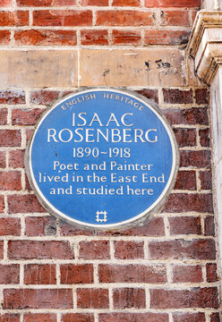 Blue plaque honoring war poet and artist Isaac Rosenberg near Aldgate East Station entrance, Whitechapel, East London, United Kingdom.