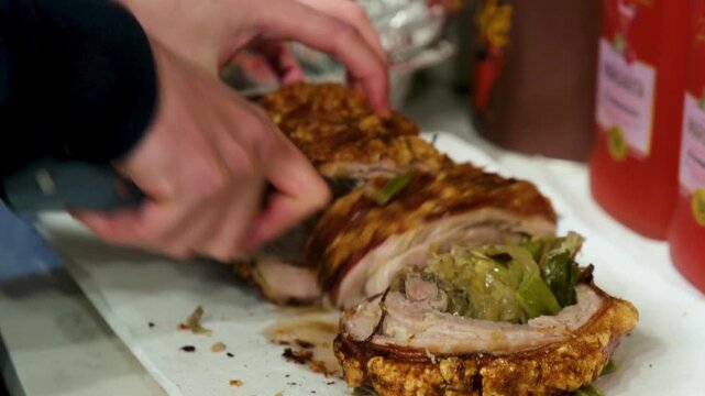 Enjoying filipino belly lechon with sides at a local gathering. Filipino belly lechon is served with local sides at a gathering. Guests enjoy the dish and share a meal together.