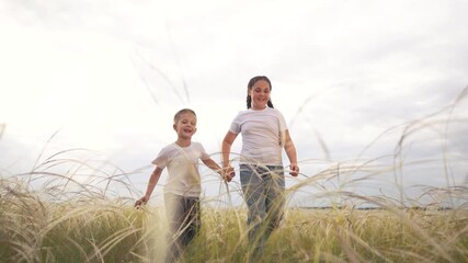 Mother and son walking through tall grass. Children walking in field holding siblings. A man and a woman bonding outdoors with a female. A mother and her son strolling through the tall lifestyle.