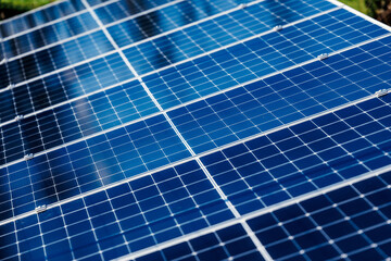Solar panels with blue reflective surfaces arranged in a grid pattern, capturing sunlight efficiently, showcasing renewable energy technology and sustainable living concepts