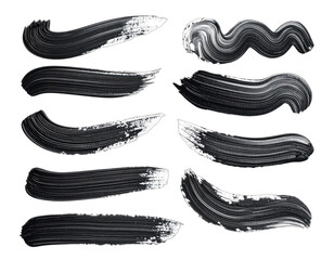 Collection of ten dynamic black paint brush strokes isolated on a black background.