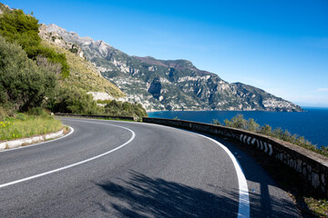 Positano and the Amalfi Coast seen from the road, with the characteristic coastal road in the foreground. Magical places in Italy © AShots
