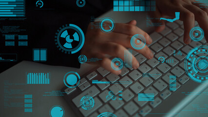 A close-up view of hands typing on a computer keyboard, surrounded by futuristic digital interface elements and data visualization graphics, showcasing modern technology concepts. Xenic