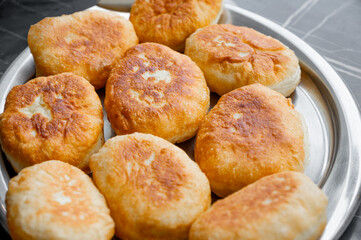 Fried Pies Made from Yeast Dough on a Tray on the Table