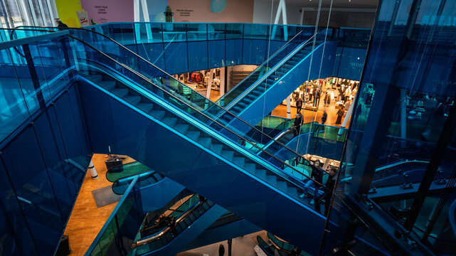 Crossing escalators in modern shopping mall interior
