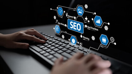 A close-up of hands typing on a keyboard with a backdrop of digital SEO icons and graphics, symbolizing keyword research, data mining, and effective planning practices. Tessel