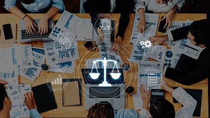 A dynamic business meeting showcasing teamwork and technology with digital icons symbolizing analysis, communication, and legal concepts in a modern workspace setting. Raster