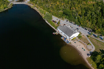 An aerial view on Lily Lake and the Lily Lake Pavilion in Saint John, NB. View high enough up that cars and people not identifiable. Sunny day.
