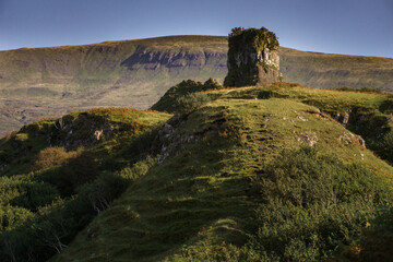 Unique rock formations and grassy hills at the Fairy Glen on the Isle of Skye