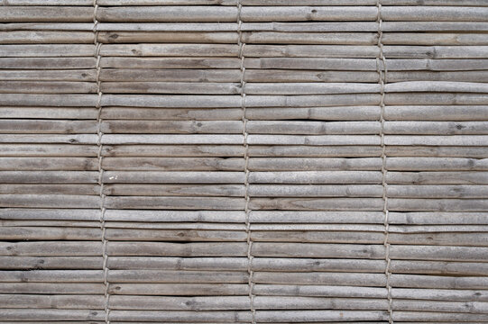 Textured background made of woven textile and reed elements in light brown and off-white tones, creating a natural and minimal abstract surface Iz-Zeytun, Malta, 10 DEC 2025.