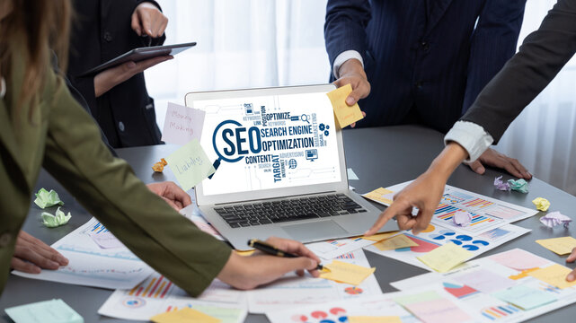 Analyst team use sticky note for creative and analytic brainstorm for business idea with BI data dashboard on laptop screen. Analysis financial data visualization tech for marketing strategy. Prodigy - Powered by Adobe