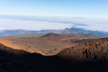 Naklejka premium View from the trail to Pico Viejo over volcanic cones, lava fields, pine forest and sea of clouds in Teide caldera, Teide National Park, Tenerife, Canary Islands, Spain.