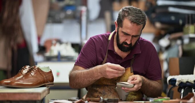 Skilled Shoemaker Expertly Crafting Leather Shoes with Traditional Tools in a Workshop