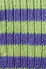 Fototapeta premium Close up textured hand knitting pattern rib 2x1 made of wool yarn for relaxing hobby background
