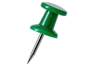 Macro shot of a green push pin against a stark black background