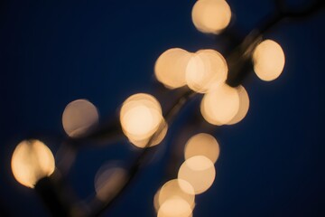Fototapeta premium Abstract shot of illuminated string lights against the night sky