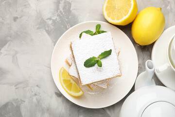 Tasty lemon bars with mint and fresh fruits on grey marble table, flat lay. Space for text
