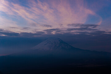 Popocatepetl volcano summit covered in snow at dusk