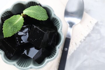 Tasty herbal jelly with mint leaves on light table, top view © New Africa