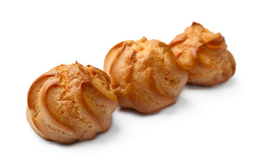 Three delicious golden profiteroles isolated on white