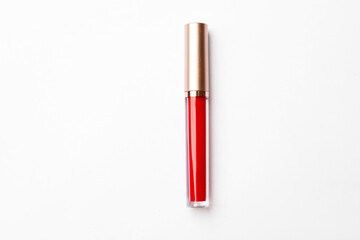 Beautiful red lip gloss on white background, top view