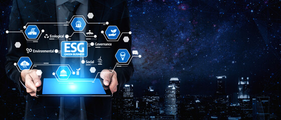 A business professional is engaged with a tablet displaying ESG icons, symbolizing crucial aspects of environmental, social, and governance principles in modern investing. Tessel