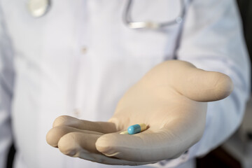 Doctor holding medical capsules in hand for patient healthcare