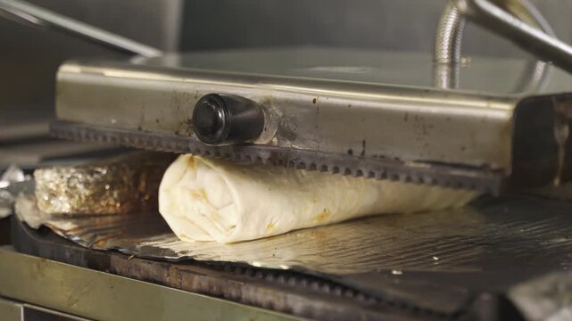 In a lively street kitchen, a skilled chef wraps juicy shawarma on the grill, showcasing expert techniques and delicious spices. Each detail brings flavor to life.