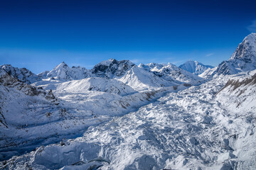 Helicopter flight over the huge Khumbu glacier. Bird eye view of the snow covered Khumbu valley. Everest base camp trek, Himalaya mountains, Nepal.