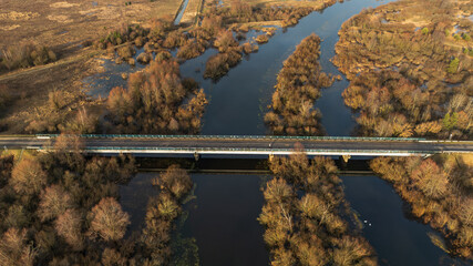 Aerial highway bridge over winter wetlands and river in Belarus