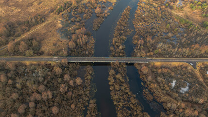 Aerial winter bridge over winding river and wetlands in Belarus