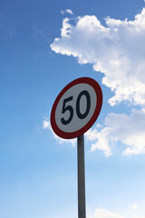 Road Speed Limit Sign Against Sky