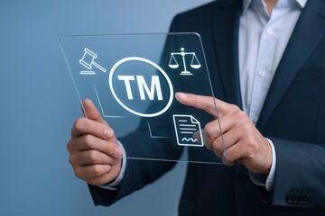 Fototapeta premium Protecting Your Brand: Businessman Interacting with a Holographic Interface Displaying Trademark Legal Protection Symbols