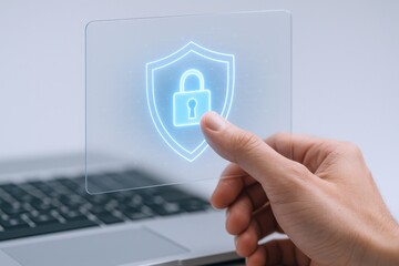 Data Protection Concept: Hand Holding Transparent Screen with Shield and Padlock over Laptop for Security