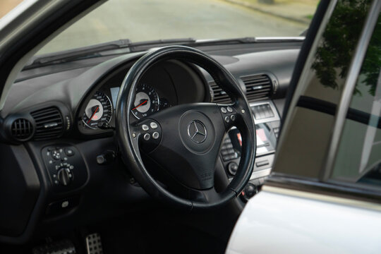 Black Mercedes-Benz C55 AMG steering wheel view, Open door interior cockpit