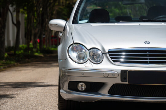 Silver Mercedes-Benz C55 AMG front view close angle, Classic German youngtimer outdoors