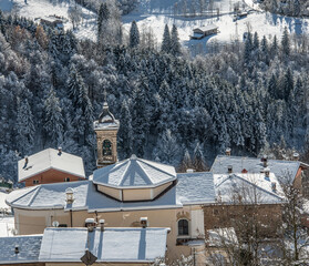 Church roof with snow-covered bell tower