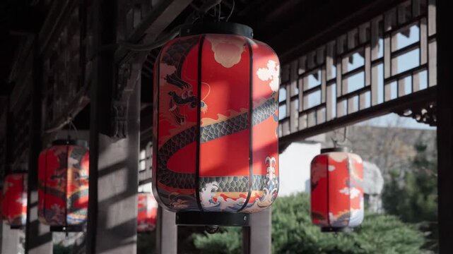 Red lanterns hung from wooden frames along the corridor, each painted with a dragon, along with patterns of clouds and waves, and swayed gently.